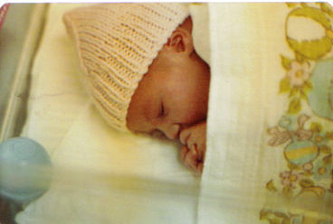 Newborn in hospital bassinet